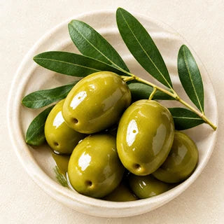 Green olives with olive leaves